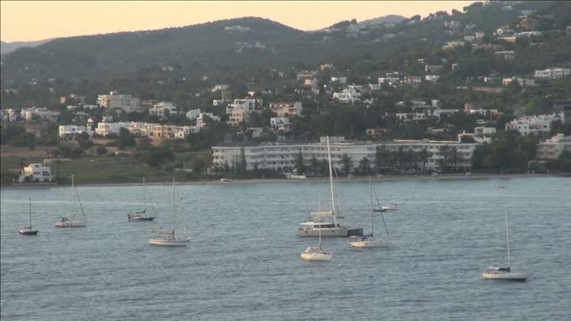 boats floating in city harbor in spain