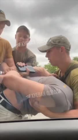 Ukrainian recruitment officers help a volunteer to get to the front lines.
