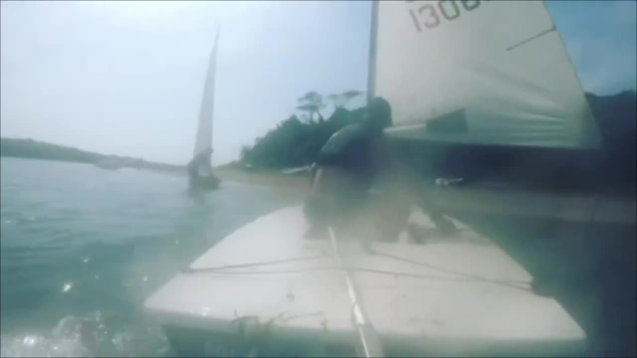 Guy Gets Shoved off Board by Sail While Windsurfing