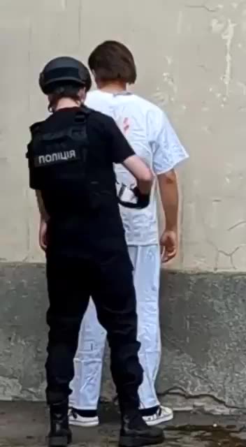 Why are they painting blood on this guy?