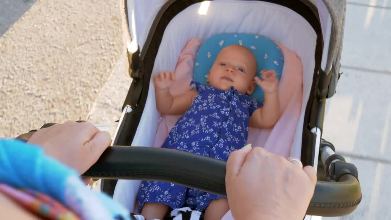 Pushing a young baby in a pram