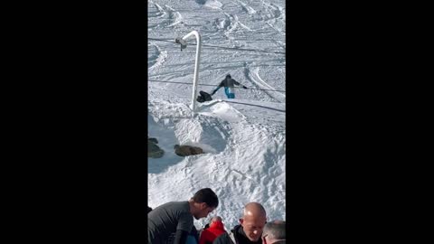 Dad pushes kid in stroller while he's skiing