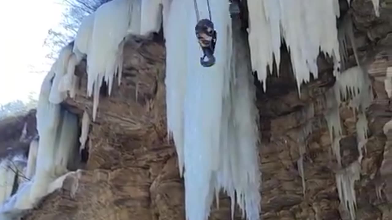 Removing a large hazardous icicle.