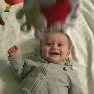 Baby Boy Adorably Cracks Up Every Time Toy Ball Is Dropped On Him