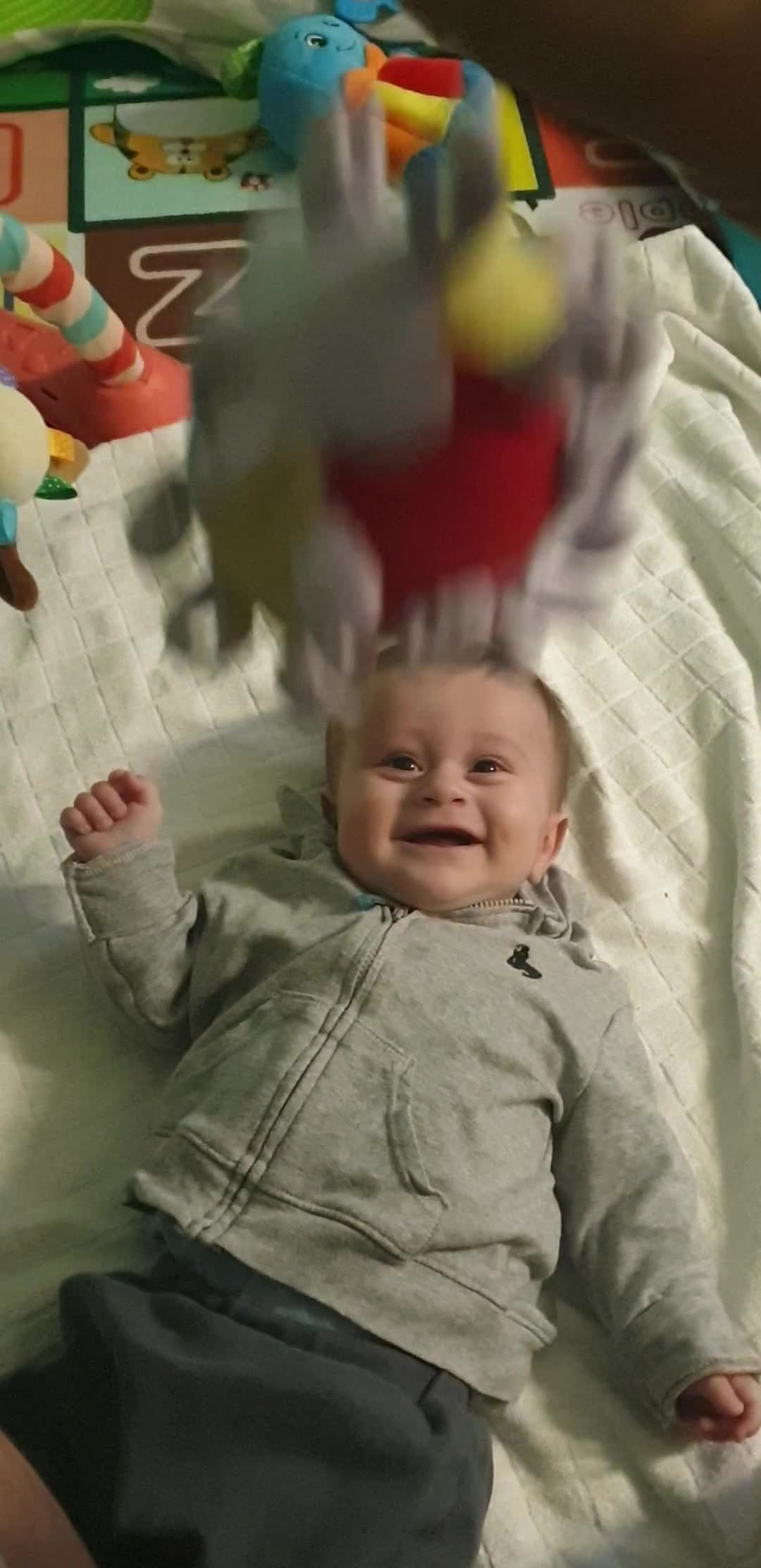 Baby Boy Adorably Cracks Up Every Time Toy Ball Is Dropped On Him