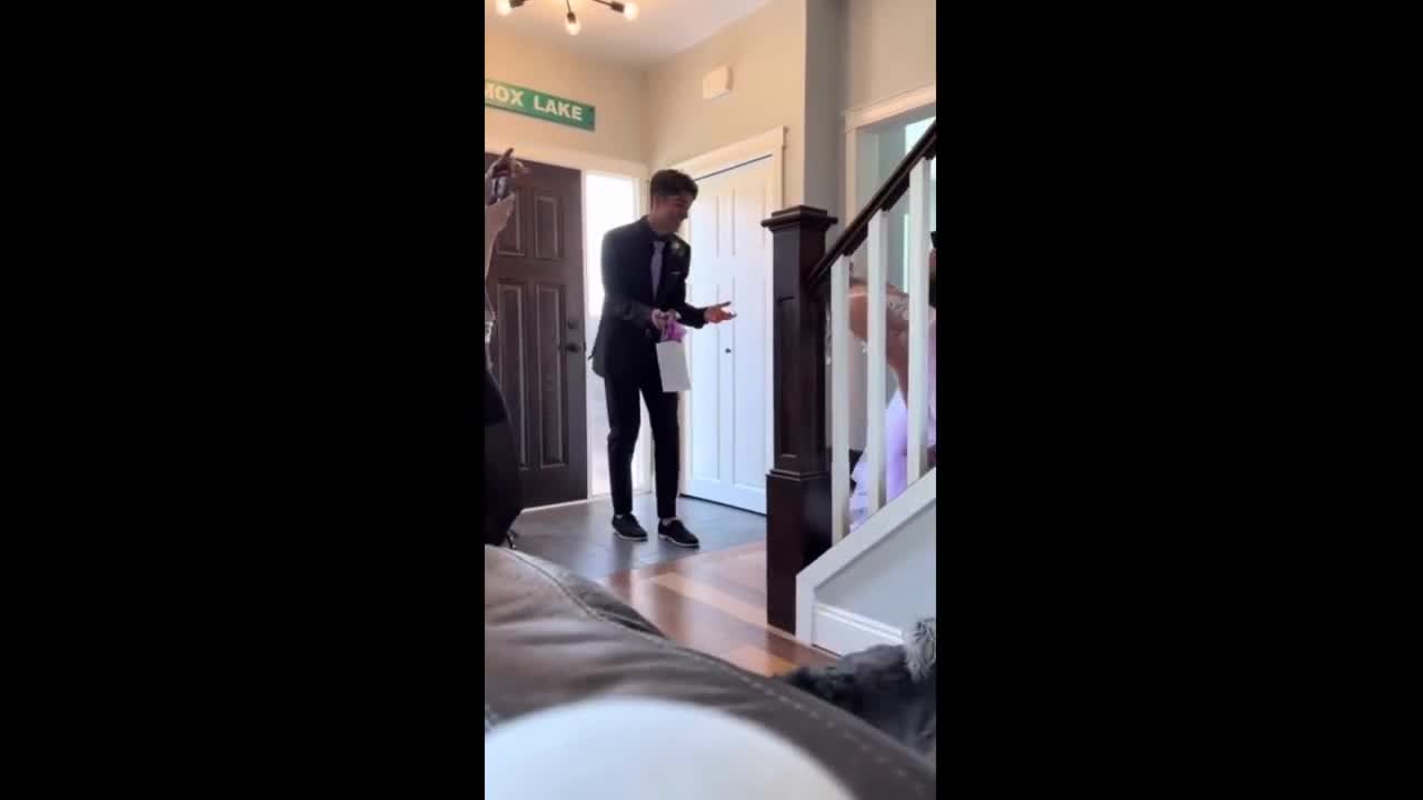 Boyfriend has emotional reaction to his date's prom dress reveal