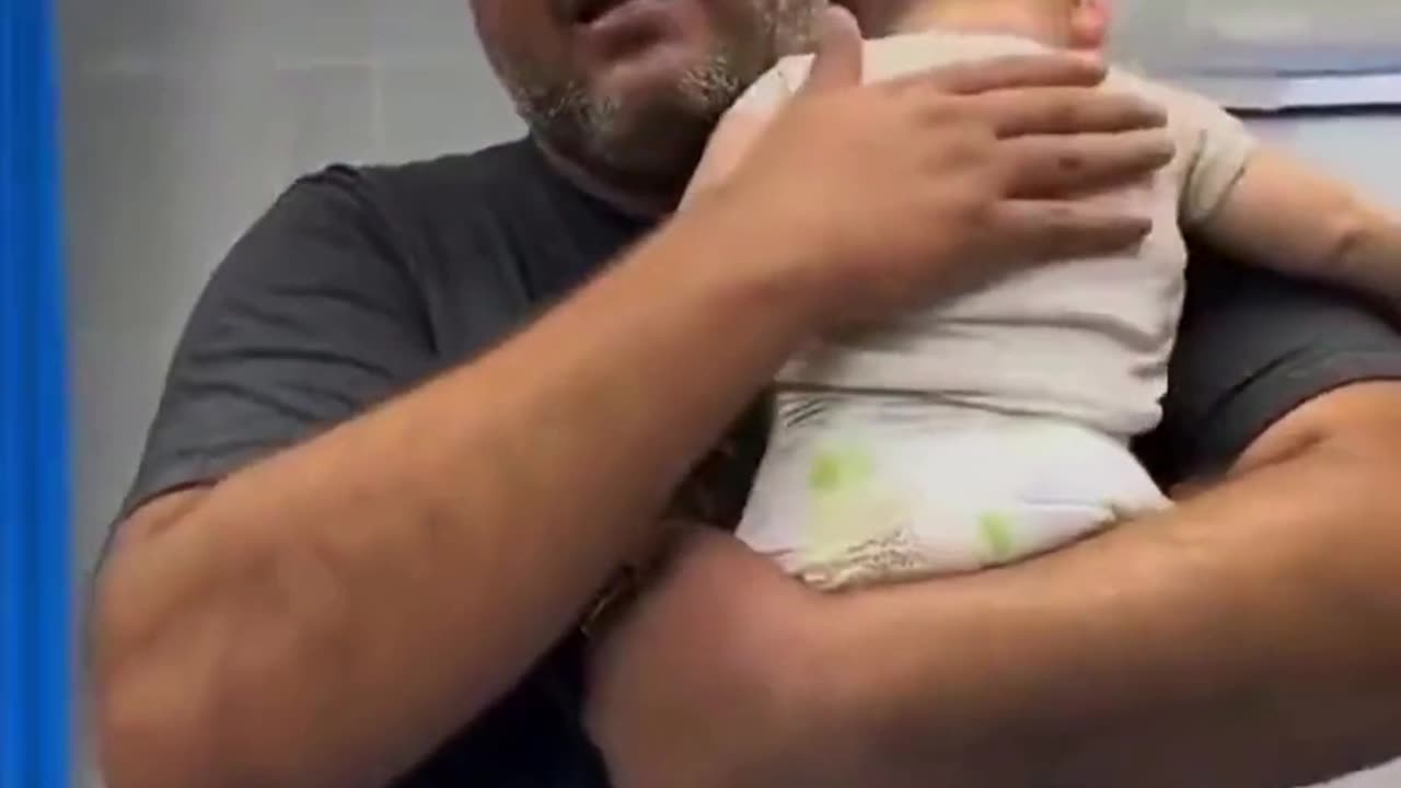 Palestinian Father Cradles Dead Baby