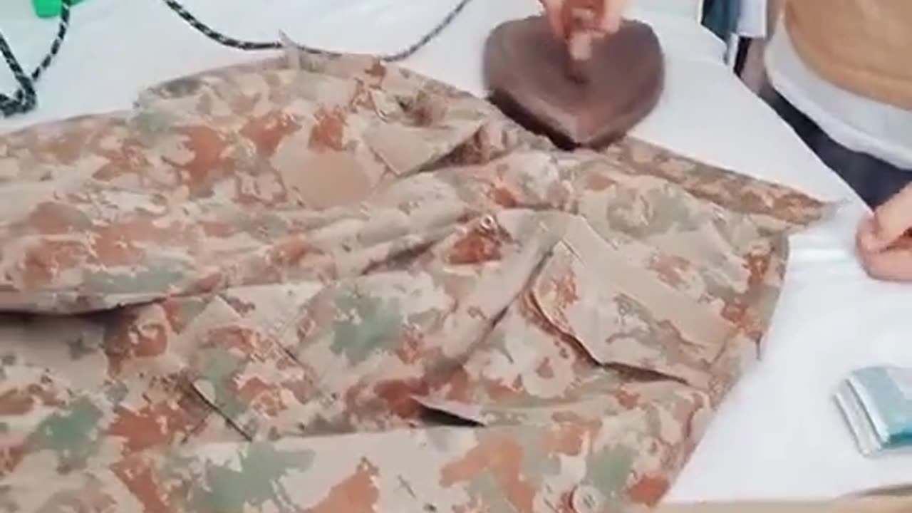 Army persion make his uniform perfect with iron