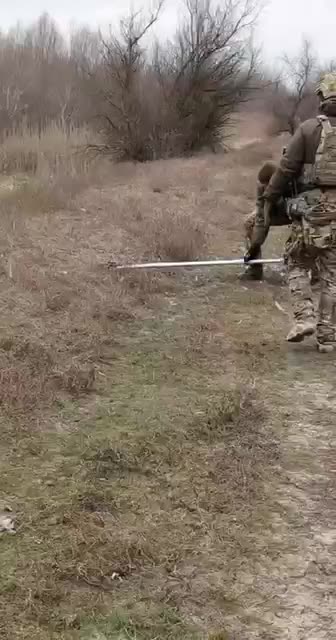Wagner soldiers remove an anti-tank mine with a canoe oar