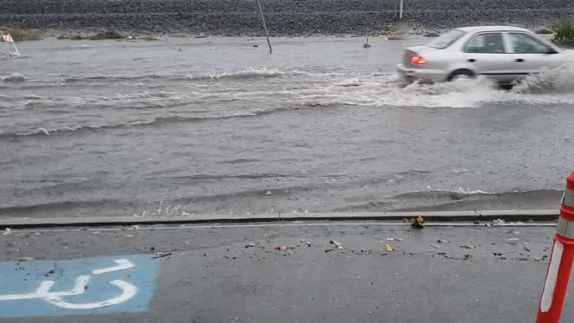 Clogged storm drain causes main road to flood