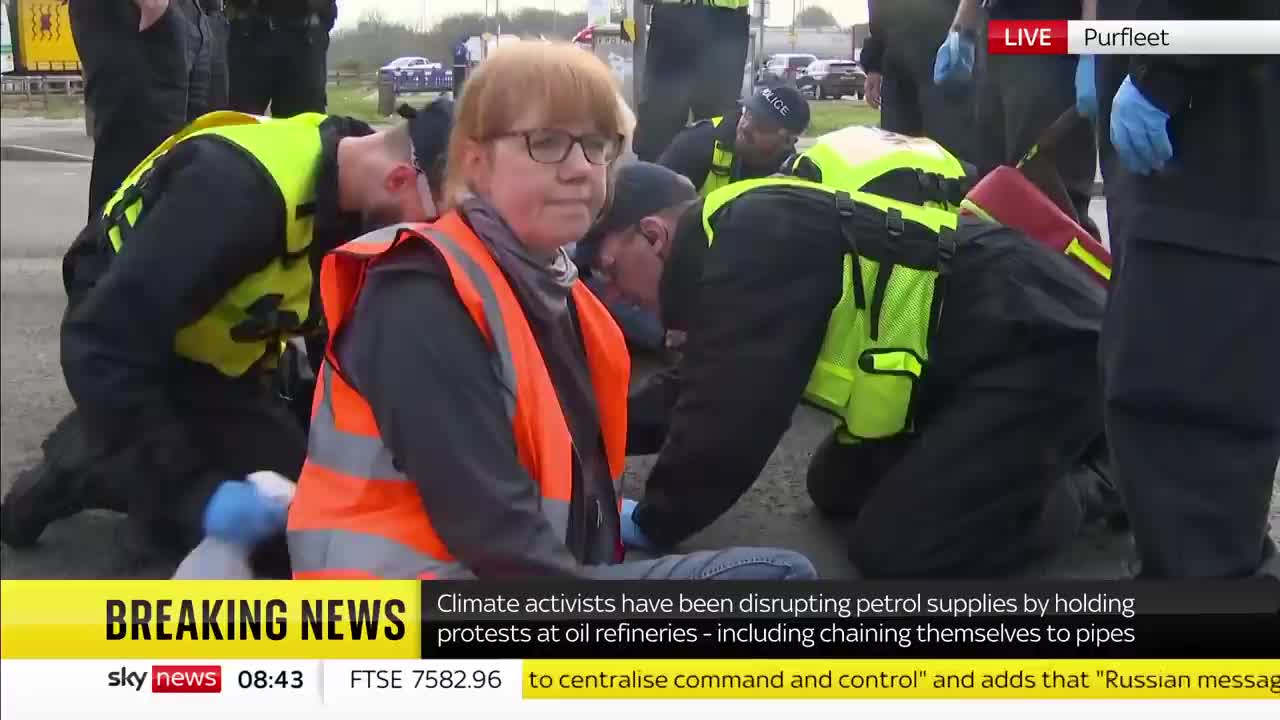 Climate activist interviewed while glued to road
