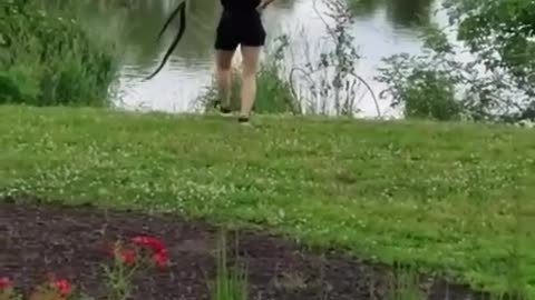 A woman puts a snake in the lake and sets a great example.