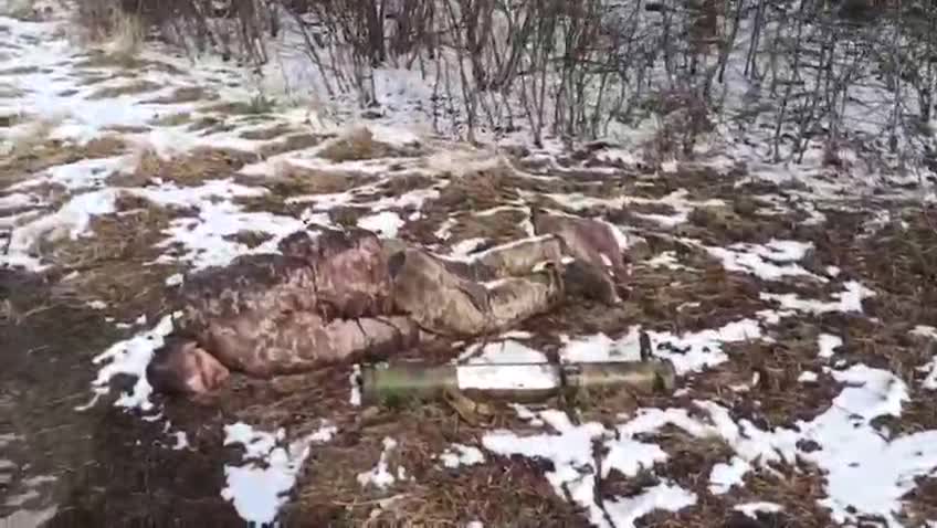 Locals pass by the killed Ukrainian soldier
