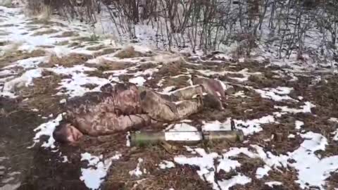 Locals pass by the killed Ukrainian soldier