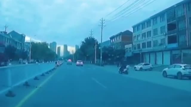 The old Chinese man was hit by a car while crossing the road