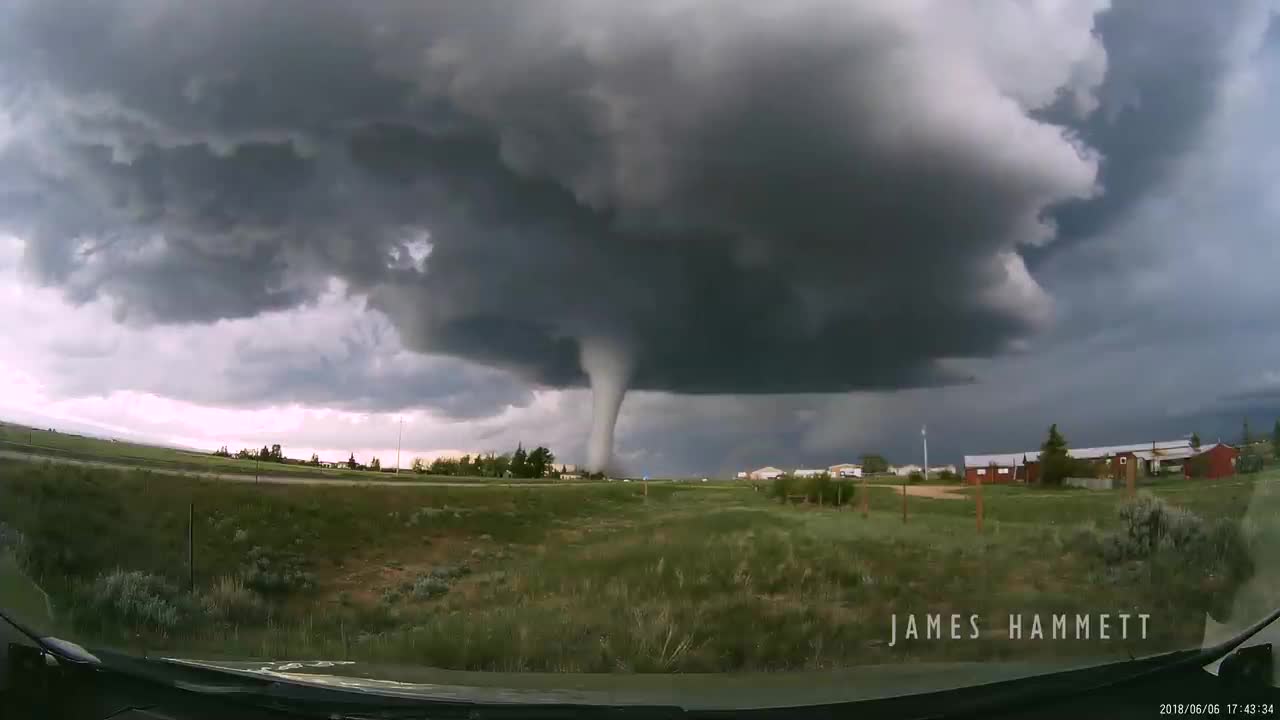 Storm chasing dashcam: Tornado crossing the highway! Laramie, Wyoming