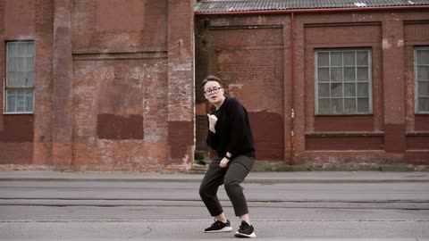 Modest girl dancing on the street.