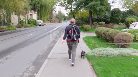 Woman in sports clothes with backpack walks