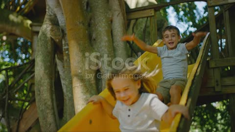 little kids having fun getting off the swing