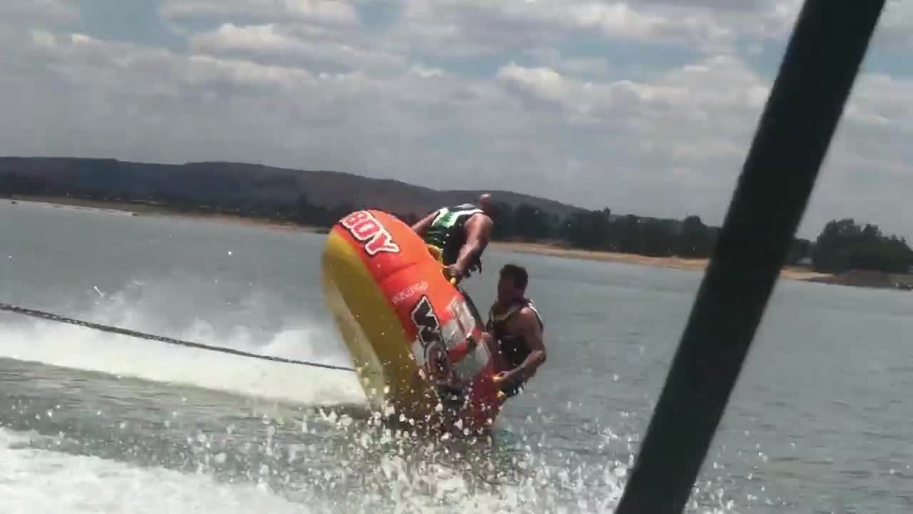 Two Guys Flip Into Water While Tubing in South African Summers