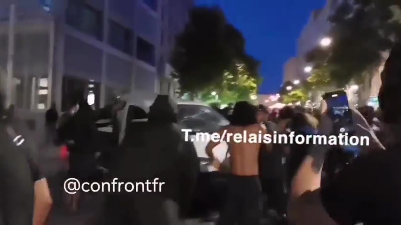 French protesters vandalize vehicles parked on the road in Marseille.