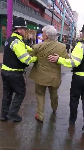 British police officers detain elderly man dressed in a suit to ‘prevent potential breach of peace’