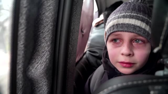 'We left our Dad in Kyiv' -little boy chokes back tears