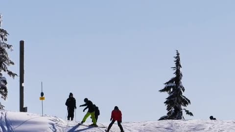 Tourists skiing on a snowy slope