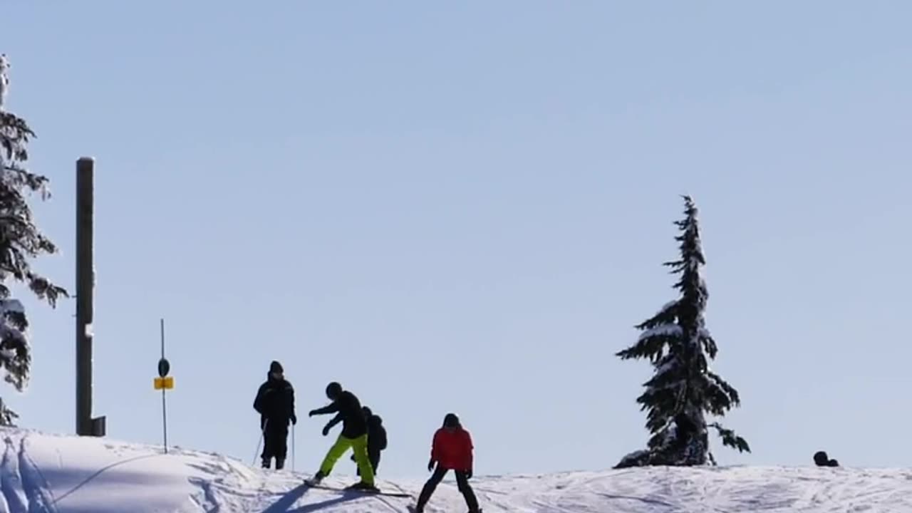 Tourists skiing on a snowy slope