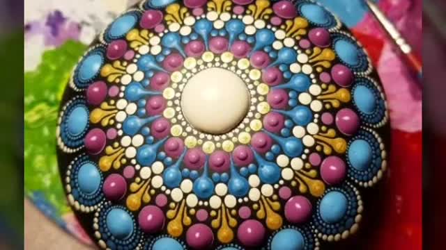 beautiful and unique mandala dotted painting on rock and stone