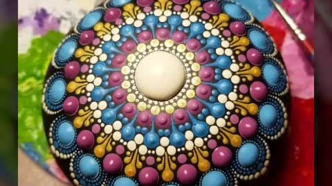 beautiful and unique mandala dotted painting on rock and stone