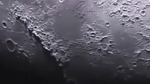 UFO flies very low over the moon