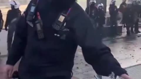 Brussels EU HQ: Some officers standing with farmers sharing cakes at barricades..