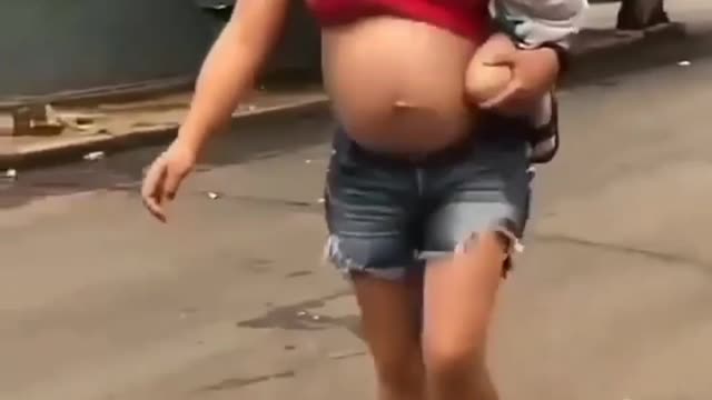 Pregnant Mother Joggles Football. She is Good