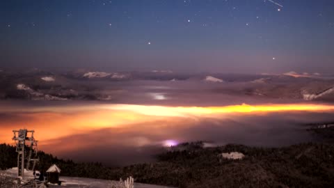Landscape with illuminated clouds at night