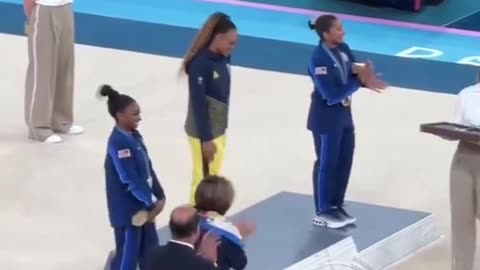 Simone Biles and Jordan Chiles bow down to Rebeca Andrade on podium