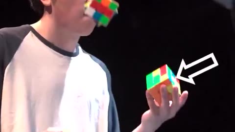 Solving Rubik’s Cubes, while juggling them.