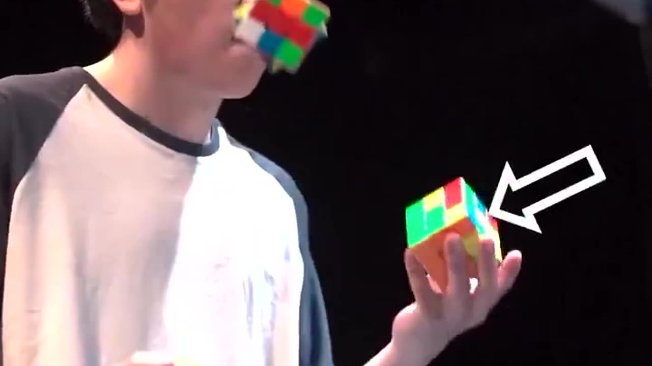 Solving Rubik’s Cubes, while juggling them.