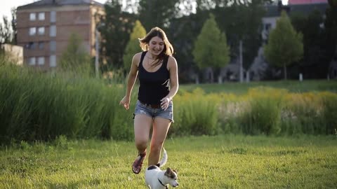 girl playing with her dog somewhere in the park