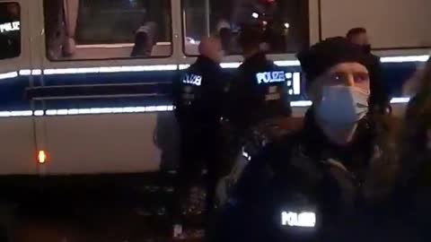 Police beat a woman following the arrest at a protest against Covid restrictions in Berlin