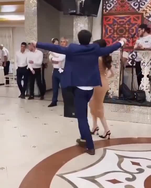 The Girl Is Elegantly Affectionately Dancing At The Wedding With The Guys