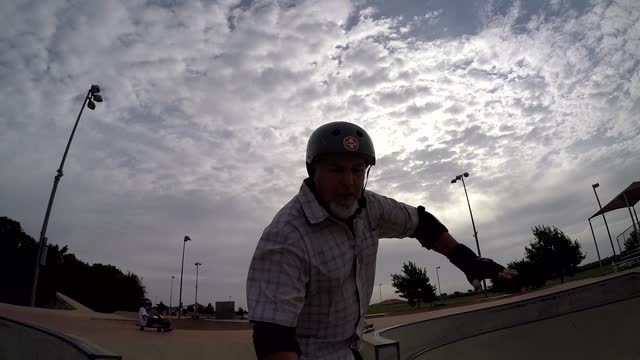 Some nice slow motion and camera angles of an old skateboarder riding a bowl.