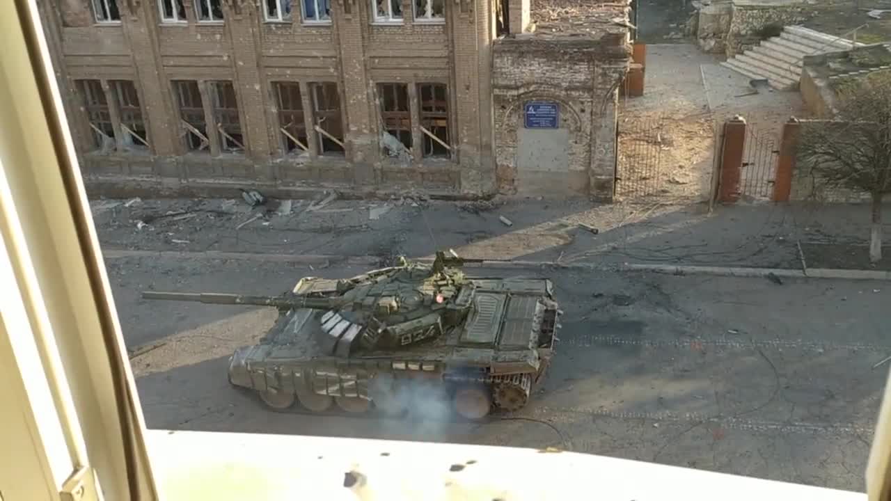 A Russian tank hit in the rear by an anti-tank missile