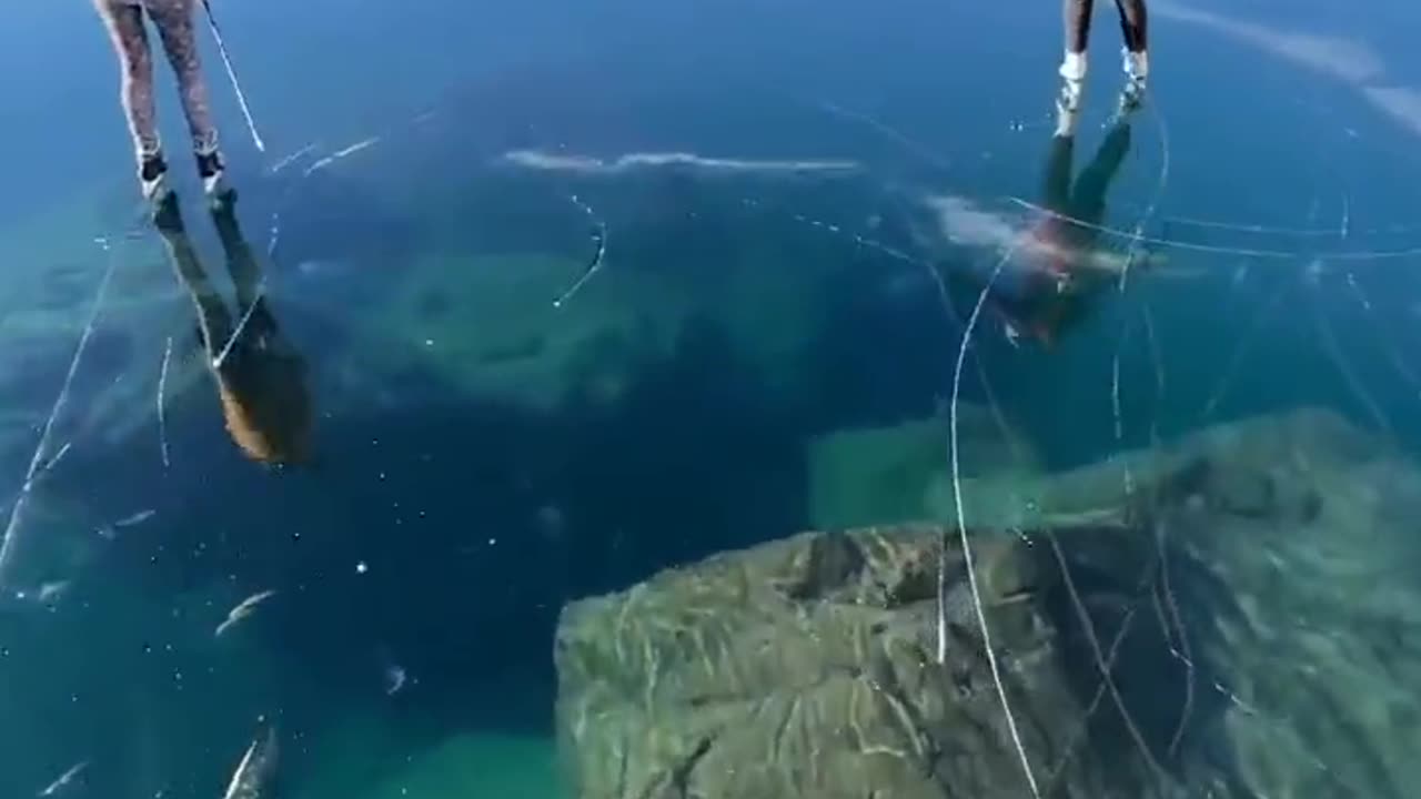 Skating over the clear glassy ice of rabbit lake in Canada