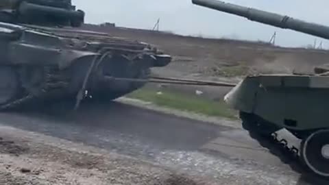 Captured T-72 towed by a Captured T-80