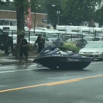 Jetski parked on side of the street