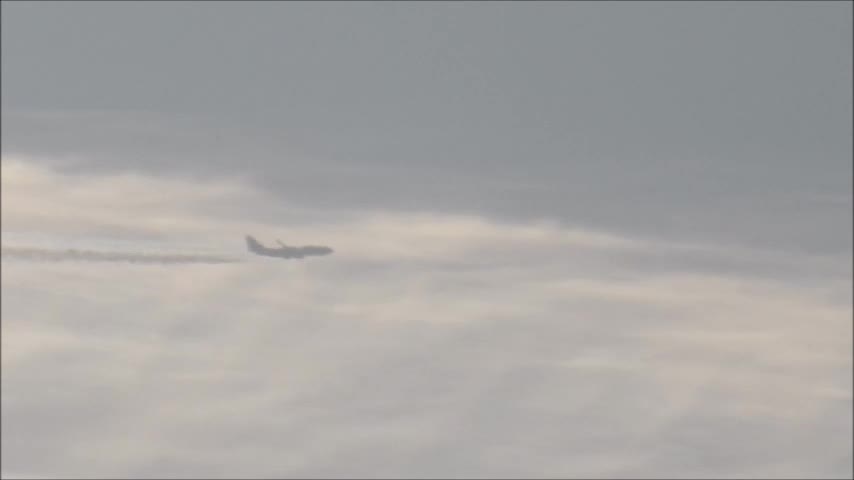 Airplane flying through a "contrail"