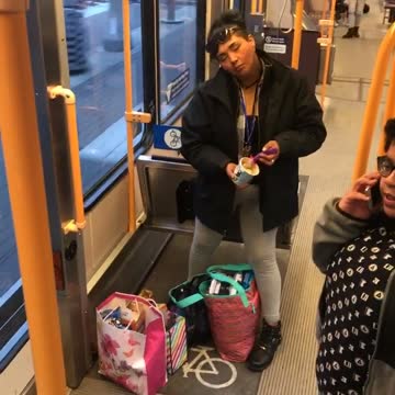 Woman in bus asleep while standing