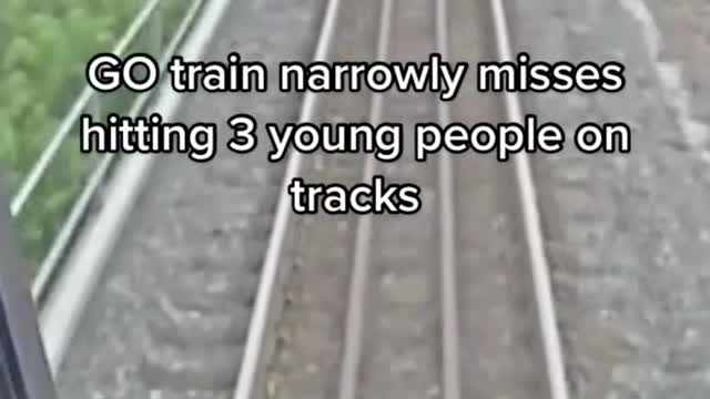 Go train narrowly misses hitting 3 young people on tracks