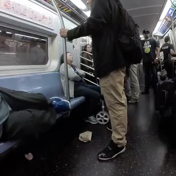 Fish eye lense man in blue shirt passed out on train